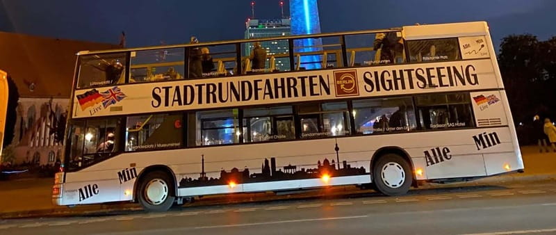 Berlin: Bus Tour by Night with Live Commentary - Potsdamer Platz and Friedrichstraße: where the lights feel theatrical