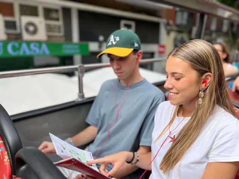 City Sightseeing Madrid Panoramic Bus Tour & Bookable Extras - Entering Madrid on the red and green double-decker routes