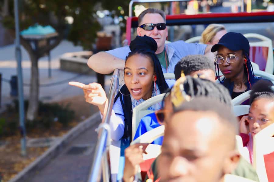 Johannesburg: Hop-On Hop-Off Bus with Optional Soweto Tour - The bus experience: open-top sightseeing with 8-language audio and live tracking